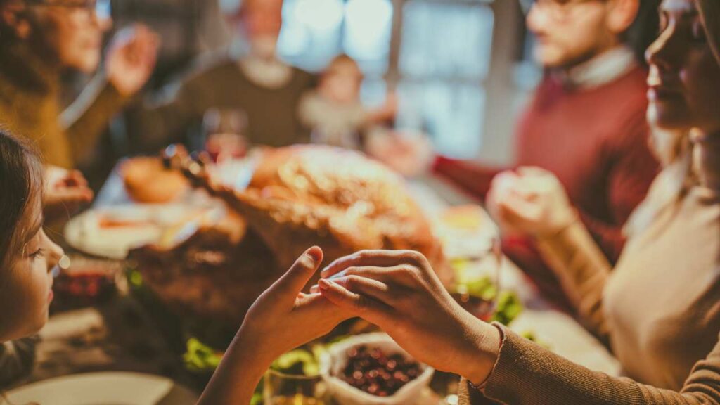 a group of people at a thanksgiving dinner table