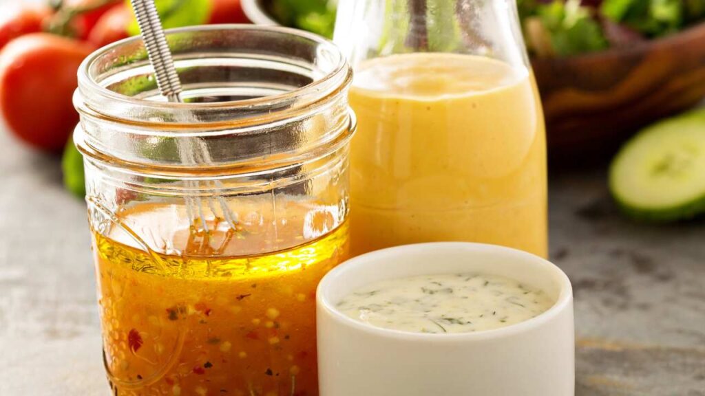 a jar of salad dressing next to a jar of dressing