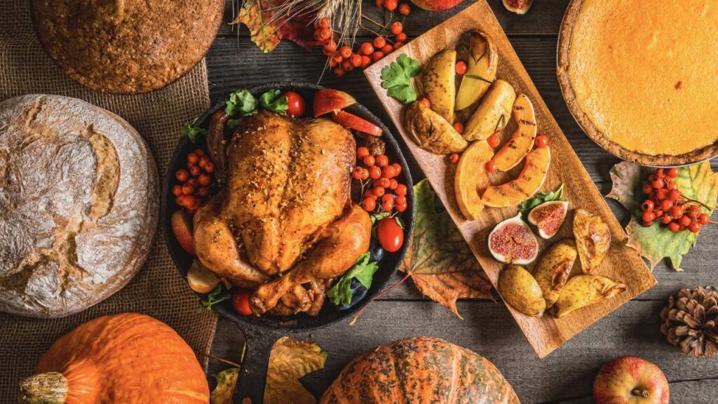 an assortment of thanksgiving foods on a wooden table