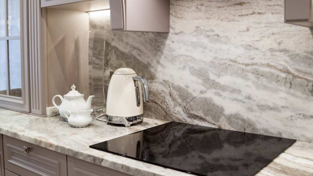 a kitchen with marble counter tops and white appliances