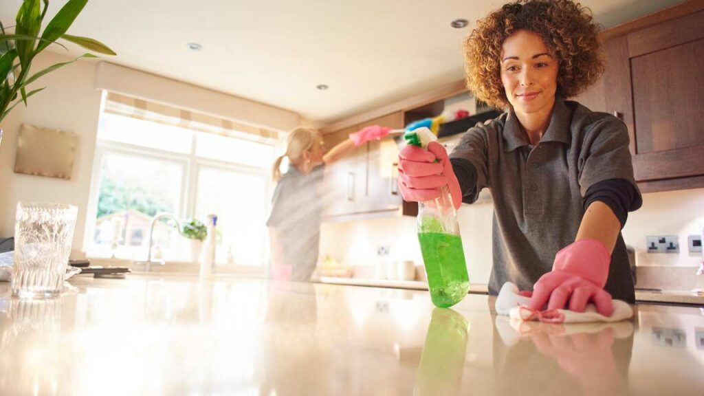 a person is cleaning a kitchen counter