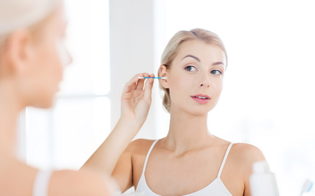 Woman cleaning her ears