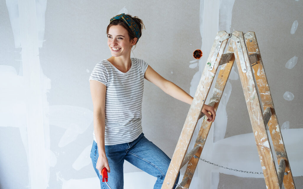 Woman repainting a room