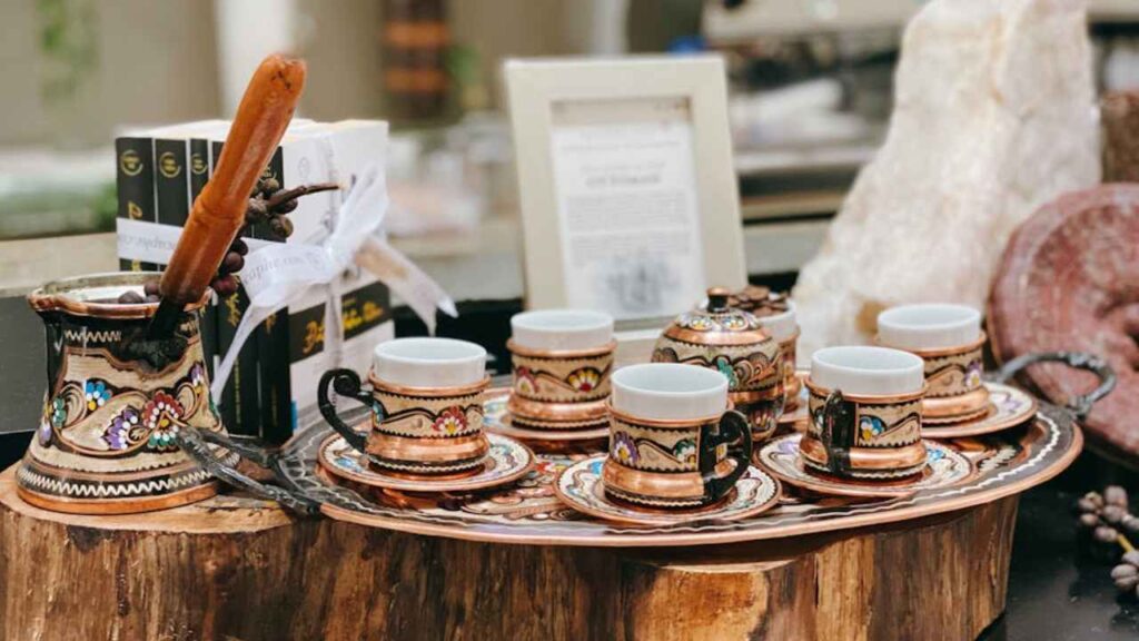 coffee cups and saucers sit on a wooden tray