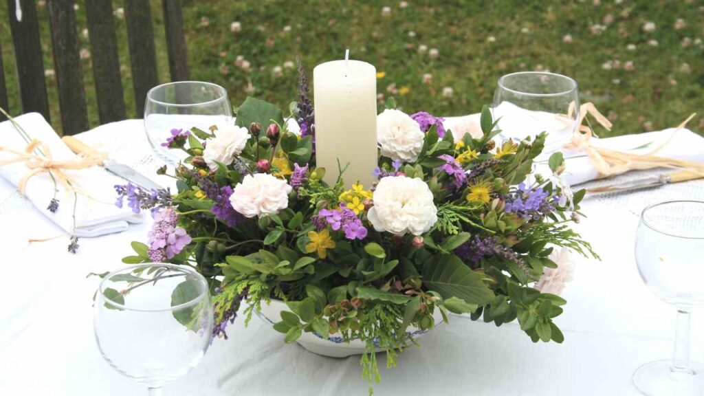 a table setting with flowers and candles on it