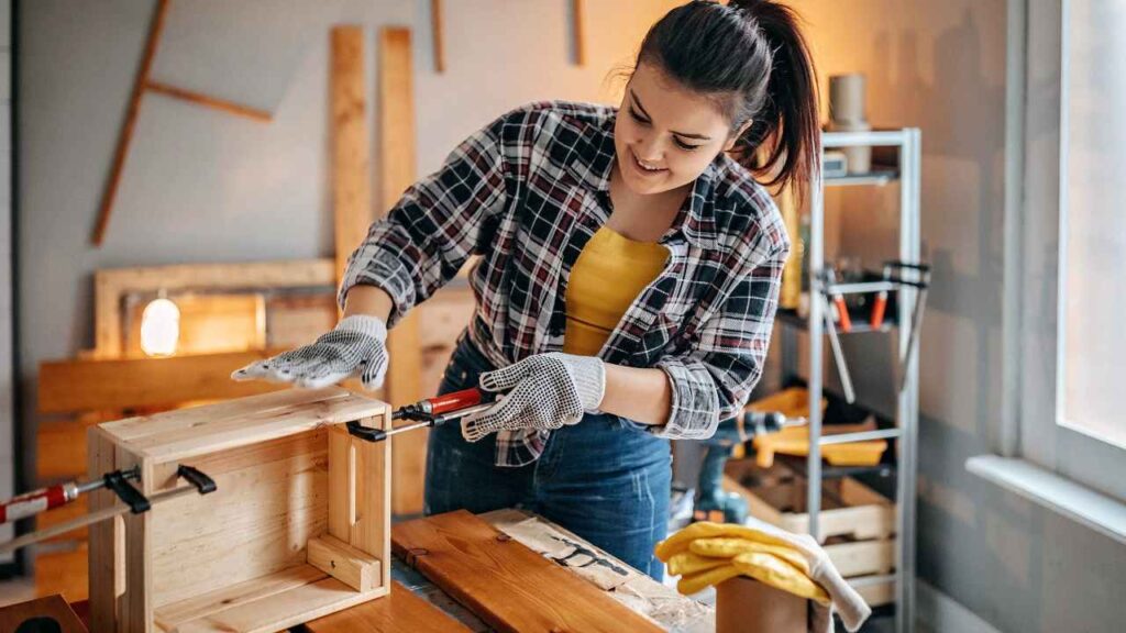 Someone is working on a wooden box in their home