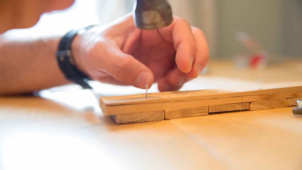 a person is using a screwdriver to make a piece of wood