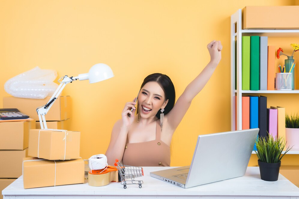 Woman celebrating a work win at her desk