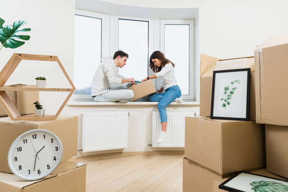 couple packing boxes in an apartment