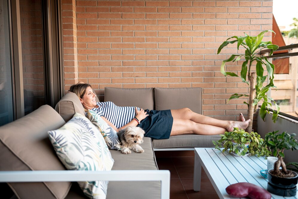 woman on outdoor couch with dog