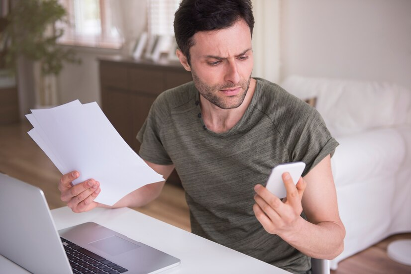 worried man looking at his phone