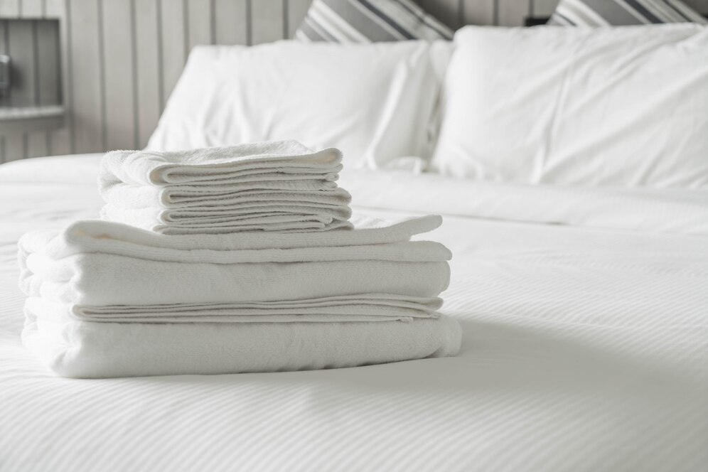 Folded linens on bed