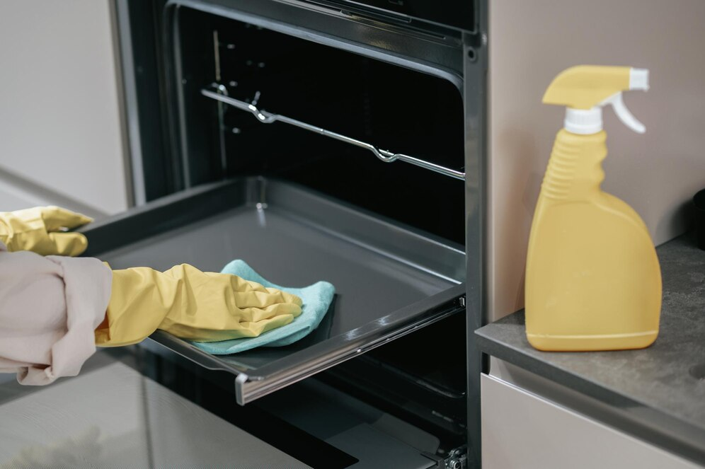 Person cleaning oven 