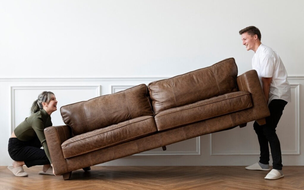 Couple moving a couch