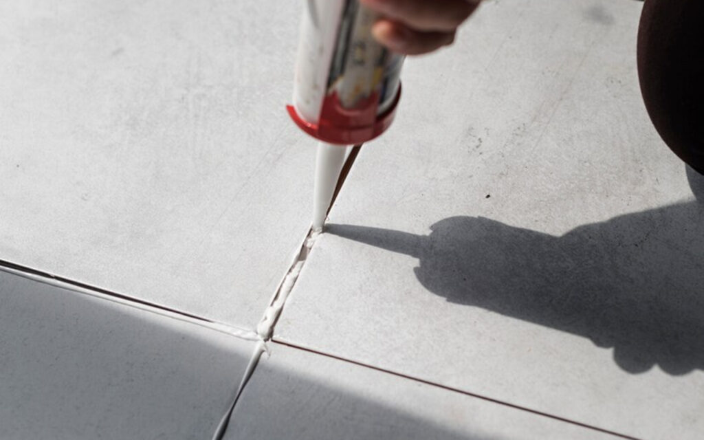 Putting grout between tiles